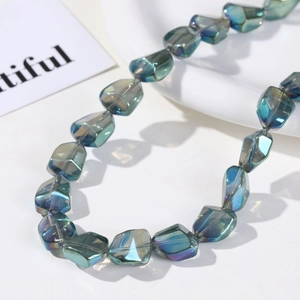Detailed macro view of AB iridescent blue-green faceted glass beads for jewelry DIY
