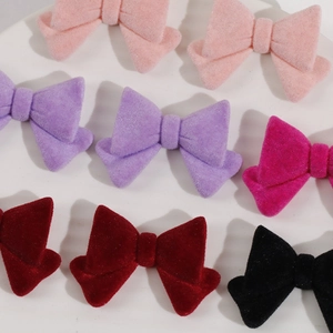 Close-up of velvet bow hair accessories in multiple colors with soft flocking texture
