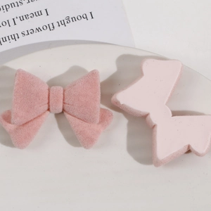 Detailed view of pink flocked bowknot accessories for DIY jewelry and hair clips