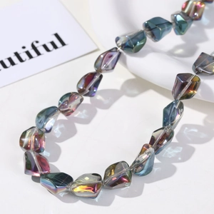 Macro detail of iridescent faceted glass beads showing multicolor gradient and shimmer