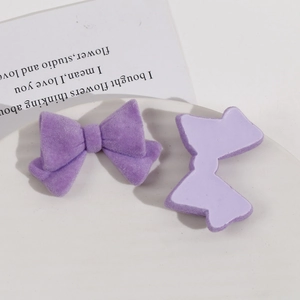 Detailed view of purple flocked bow charms for DIY jewelry and hair accessories