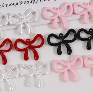 Detailed macro view of pearlescent bow-shaped DIY charms in various colors