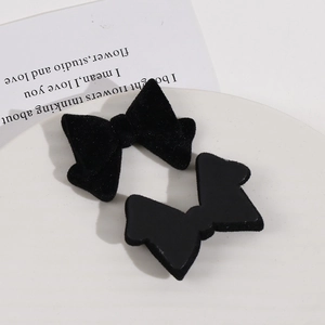 Detail view of black flocked velvet bow hair accessories with resin base for DIY jewelry making