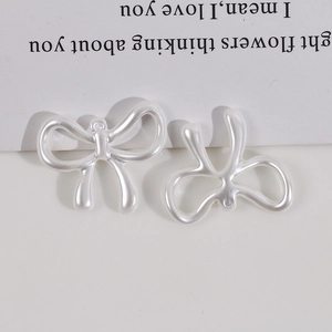 Detail of DIY pearl-white bow pendant with top hanging loop for jewelry making