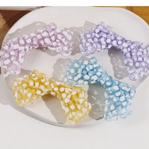 Set of four colorful acetate checkered bow hair clips in pink, purple, yellow and blue