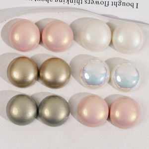 Macro detail of 18mm matte pearl and metallic acrylic beads for DIY jewelry making