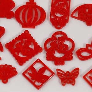 Macro detail of red translucent acrylic Chinese New Year festive charms with luck symbols