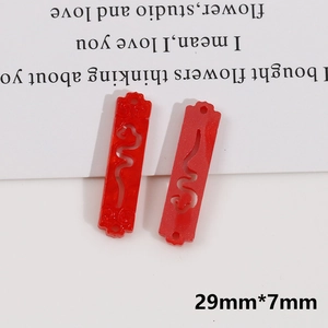 Detailed view of red hollow Chinese resin charms for jewelry DIY crafts with double holes