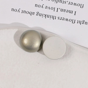 Detail of 18mm matte and pearl finish semi-round acrylic accessories in green and cream