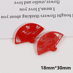 Detailed macro view of 18mm by 30mm red fan charms with festive Xi characters