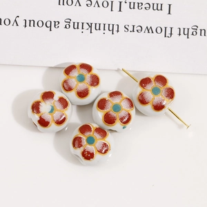 Close-up of 12mm double-sided floral ceramic beads with colorful patterns for DIY jewelry