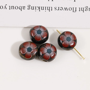 Detail of 12mm double-sided floral ceramic beads with red flowers for DIY jewelry making