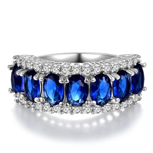 Detail of luxury silver ring with oval blue zircons and white pave-set crystals