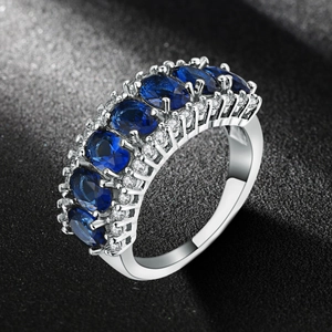 Elegant silver ring with five oval deep blue zircons and side accent stones in a row