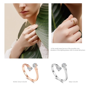 Detail view of double-stone open rings in rose gold and silver finish with bright zircons