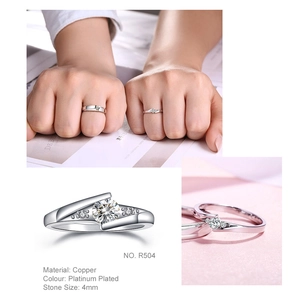 Platinum plated couple ring set featuring twist arm design with 4mm cubic zirconia
