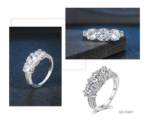 Macro view of polished silver ring featuring three large round zircons and pavé setting