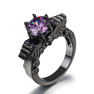 Vintage black gold skull ring featuring round purple zircon and gothic bone design