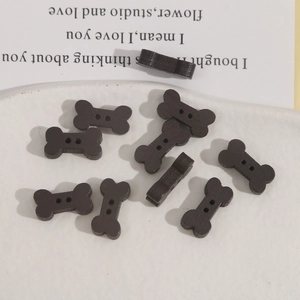 Dark brown bone-shaped wooden buttons with natural grain and two holes for DIY sewing projects