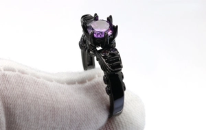 Macro detail of retro skull ring with purple zircon and black gold plating craftsmanship