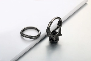 Macro detail of black gold ring set featuring large black round zircon and star setting