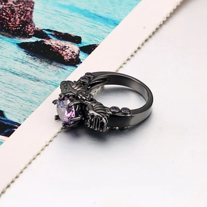 Vintage punk black skull ring with large purple zircon stone in retro gothic style