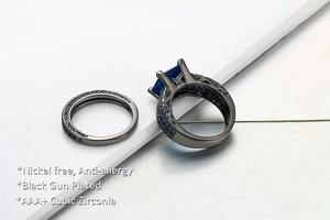 Macro detail of black gun plated rings with blue princess cut AAA cubic zirconia stones