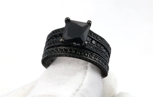 Close-up of black gold plated ring set featuring square cut black zircon stones