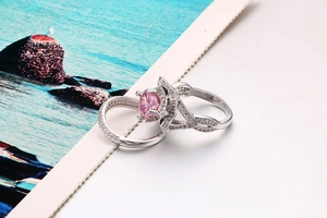 Detailed macro view of silver star ring set with a central round pink gemstone