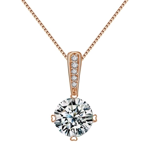 Macro detail of rose gold pendant with heart-shaped prongs and round zircon stone