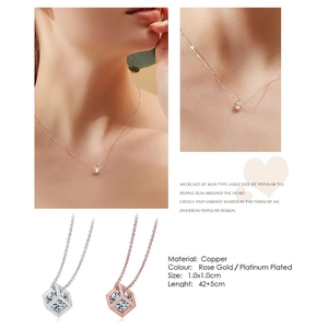 Macro detail of cube pendant necklace with zircon stone inlay and rose gold plating