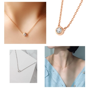 Close-up of bezel-set zircon pendant necklace in rose gold and silver finishes