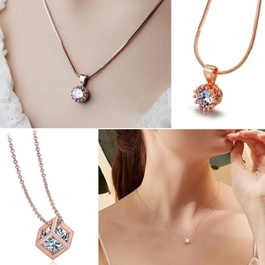 Detail of rose gold crown and hollow cube pendants with shimmering zircon stones