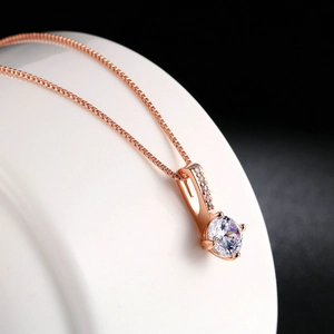 Elegant rose gold box chain necklace with a brilliant round cubic zirconia pendant