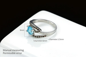 Macro detail of blue zircon ring with white gold plating and size measurements