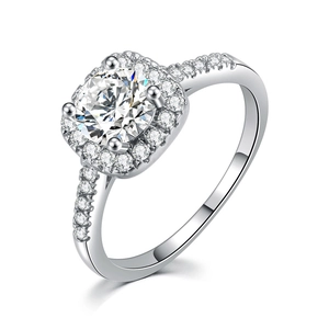 Close-up of classic silver engagement ring featuring a round solitaire with a halo