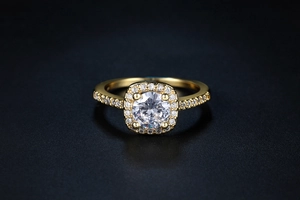 Macro shot of halo engagement ring with central round zircon and pavé side stones