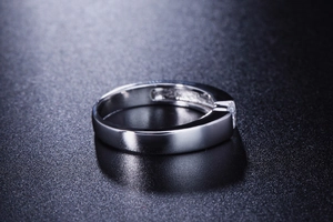 Macro shot of polished silver band ring for men with single inset diamond detail