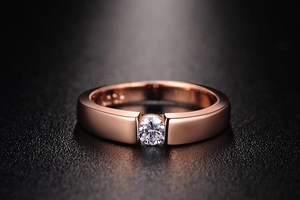 Macro shot of S925 engraved hallmark and solitaire diamond on rose gold wedding band