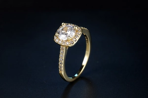 Macro detail of square cut zircon ring with shimmering halo on a dark textured background