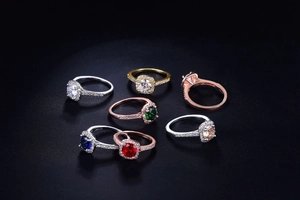 Close-up of halo zircon rings in various gemstone colors and multi-tone metal platings