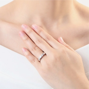 Minimalist wide band solitaire ring with a round diamond in high-polish silver finish
