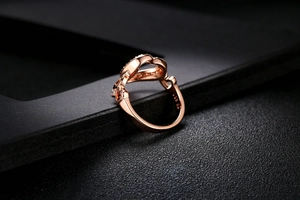Macro detail of rose gold ring featuring hollow heart design and S925 hallmark stamp