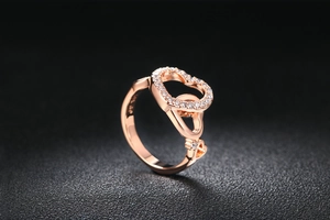 Macro shot of rose gold heart ring featuring zircon pave and S925 silver hallmark engraving