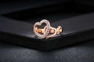 Detailed macro view of heart-shaped rose gold ring with pavé-set cubic zirconia stones