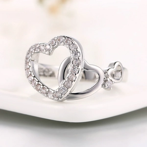 Elegant silver finish double heart ring with sparkling cubic zirconia on white background