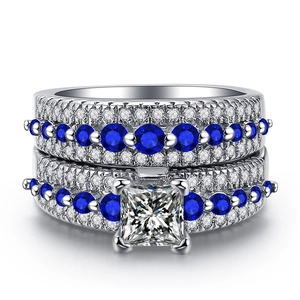 Detailed macro view of white gold plated rings with blue sapphire and micro zircon inlay