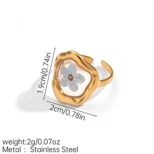 Detailed view of the 1.9cm x 2cm gold stainless steel ring with a blue dried flower inlay