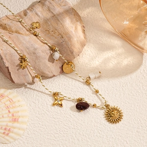 Bohemian braided chain necklace with gold sun charms, starfish, and pearls for summer
