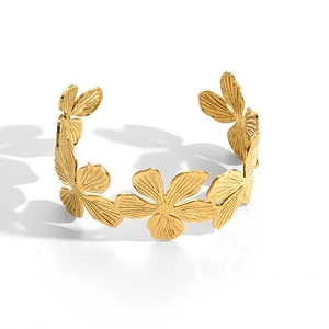 Elegant gold stainless steel open bangle featuring 3D floral pattern on white background